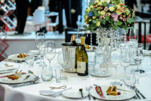 Wedding reception table with floral centerpiece, wine