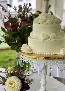 Elegant two-tier white wedding cake with roses