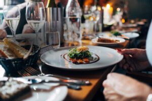 Gourmet plated dish on candlelit restaurant table