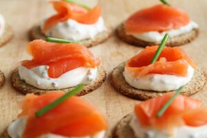 A close up of some crackers with salmon