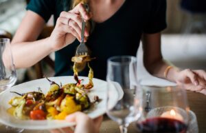 A woman is eating food at the table