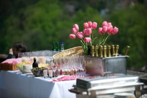 A table with many glasses and flowers on it